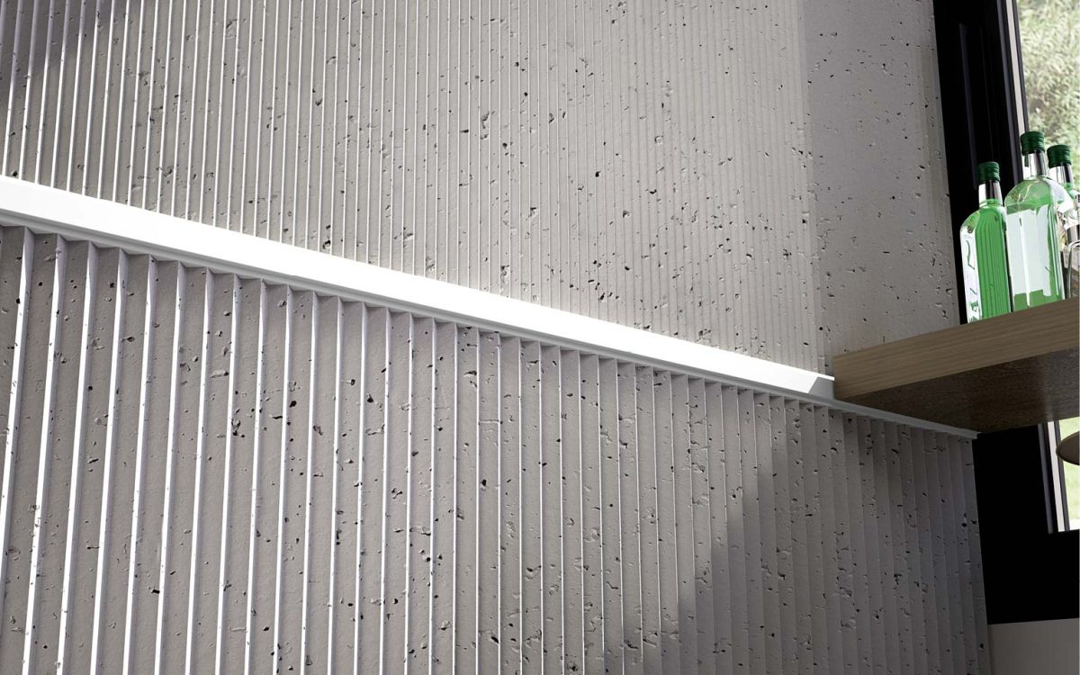 Panel decorativo SPIRIT imitación cemento en cafetería con perfil blanco combinado